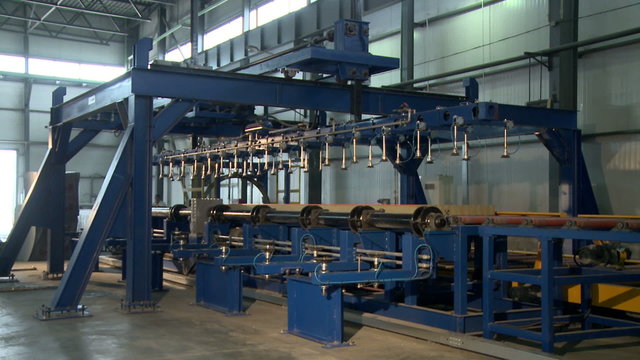 Wooden bars moves along conveyor on machine
