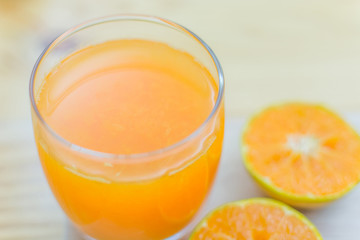 Glass of fresh tangerine, orange juice with sliced orange half o