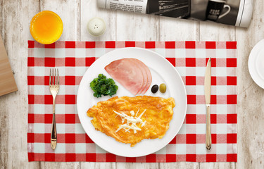 Served breakfast. Omelet, ham, salad, olive on plate. Top view.