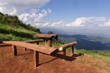 Table and chairs with grass, mountain and cloudy sky view of Chi