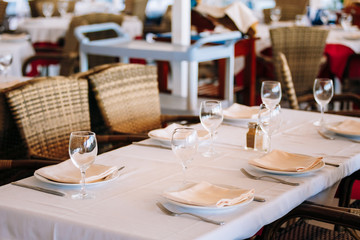 The interior of summer cafe - sheltered tables with white tablec