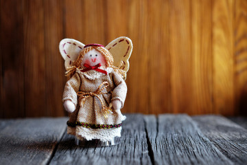 Angel stands on a wooden background