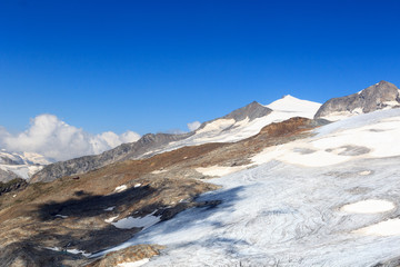 Fototapeta na wymiar Mountain glacier panorama with summit Großvenediger south face and alpine hut Defreggerhaus in the Hohe Tauern Alps, Austria