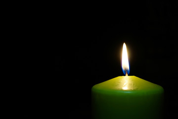 burning candle isolated on black