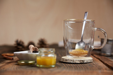 Brown sugar and honey in a tea glass and cinnamon and orange sli