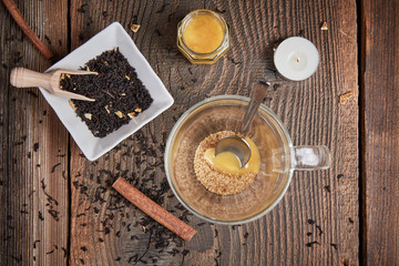 Brown sugar and honey in a tea glass and cinnamon and orange sli