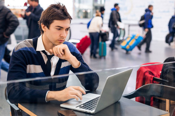 Freelancer working with a laptop in train station