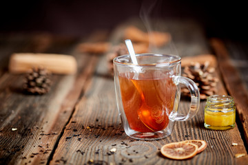 Steaming tea and honey on a wooden table - 99193737