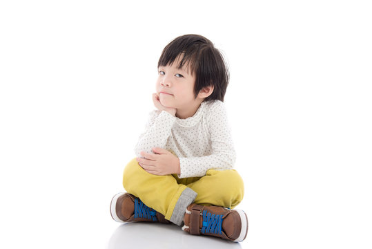 asian child sitting on white background isolated