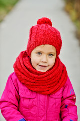little girl wearing scarf and hat