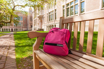 Fototapeta na wymiar Backpack laying on university bench