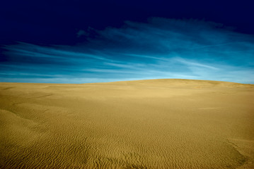 Fototapeta na wymiar Background of sandy landscape and dark sky