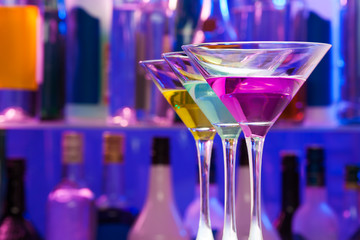 Close up of three color alcohol cocktails in bar