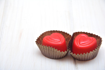 Heart-shaped chocolates on the white background  