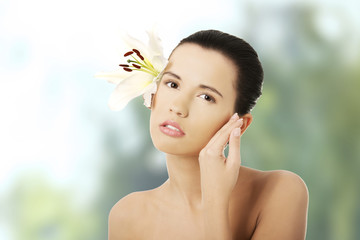 Fototapeta premium Woman with healthy skin and lily flower