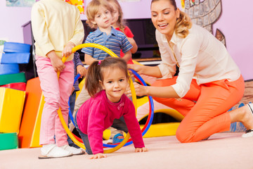 Kids with girl and teacher play active game