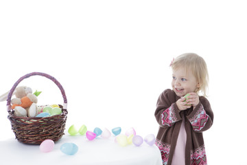 Fototapeta na wymiar Little girl playing with Easter eggs, isolated on white background