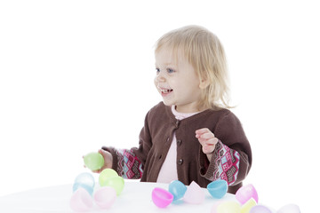 Little girl playing with Easter eggs, isolated on white background