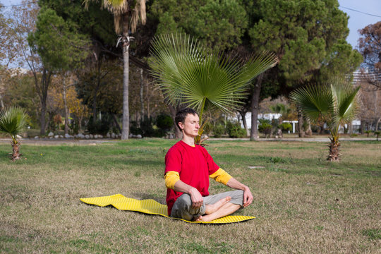 Young man practicing yoga and meditating.