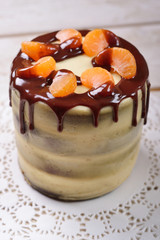 Pistachio cake decorated with chocolate and tangerine slices, ru