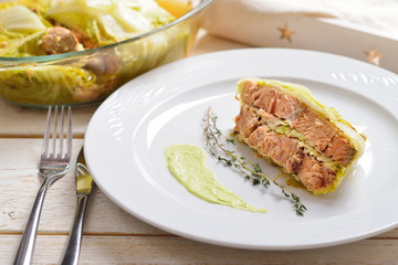 fish baked in leaves of Chinese cabbage with nuts and lemon juic