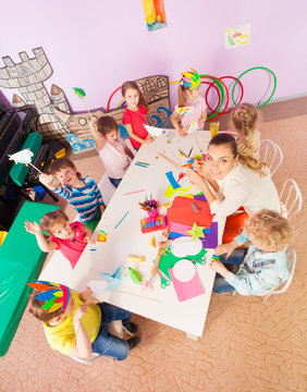 Kids Around Table In Kindergarten Class From Above