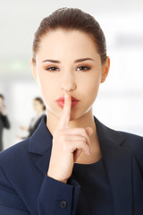 Fototapeta na wymiar Businesswoman with finger on her lips