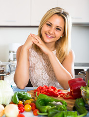Obraz na płótnie Canvas Girl cooking with veggies at home.