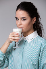 Young brunette with a glass of milk