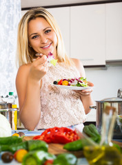 Young woman enjoying vegetable salad