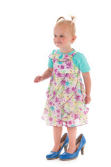 Toddler girl in mothers big shoes