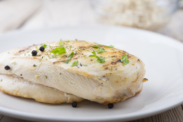 Grilled chicken breast with fresh vegetables .