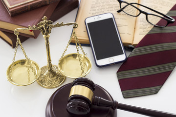 Law concept, scale, gavel, books, glasses, mobile phone and tie