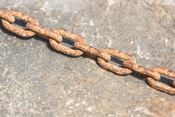 Rusty chain on a rock