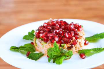 Fresh summer salad with pomegranate, tuna fish, carrots and mint