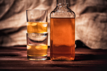 glass of whiskey with ice, a bottle of single malt whiskeys