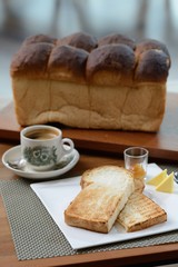 Steaming traditional oriental Chinese kopitiam style dark coffee in vintage mug and toast