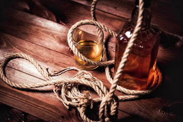 glass of whiskey with ice, a bottle of single malt whiskeys