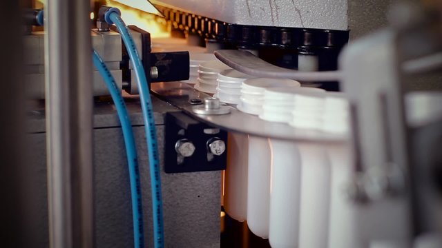 White PET bottle preform on conveyor