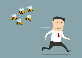 Businessman running away from angry bees