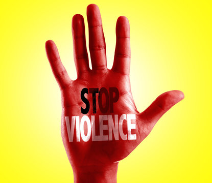 Stop Violence written on hand with yellow background