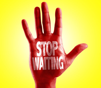 Stop Waiting written on hand with yellow background