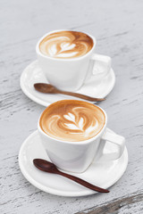Cup of latte coffee on white wood table