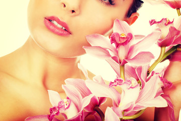 Obraz na płótnie Canvas Beautiful woman with pink flower.