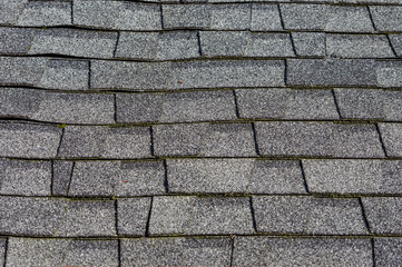 Composition shingles on a roof showing detail