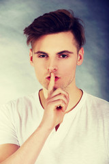 Young man showing silent gesture.