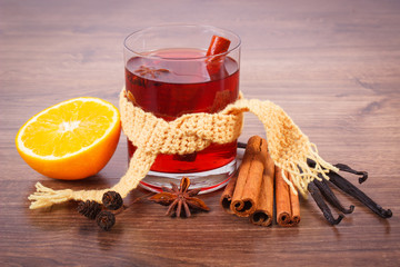 Glass of mulled wine wrapped scarf with fresh fragrant spices
