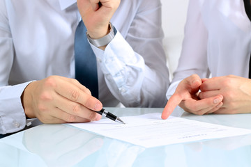 Two business partners signing a document