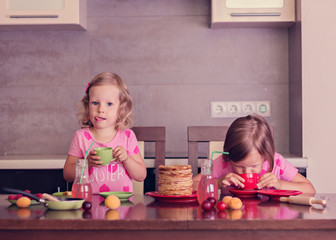 Obraz na płótnie Canvas Pancake week. Little girls (sisters) eat pancakes.