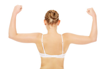 Obraz premium Back view of athletic woman show her muscles